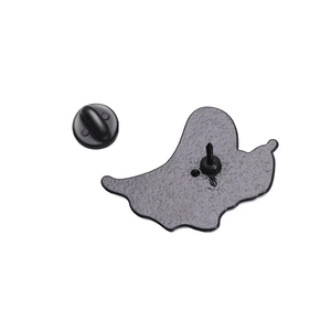 Detail view of butterfly enamel pin back with black rubber clutch and textured metal finish