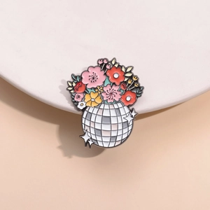 Disco ball enamel pin with colorful floral bouquet on a minimalist display stand
