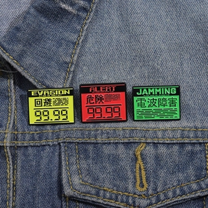 Three creative enamel pins on denim jacket showing Evasion, Alert and Jamming warning signs
