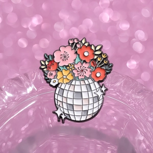 Creative colorful flower disco ball enamel brooch pin displayed on glassware edge