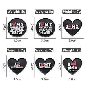 Detailed grid view of black enamel heart badges with white text and weight specifications