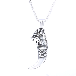 Detailed view of a stainless steel dragon head and tiger tooth totem pendant with chain