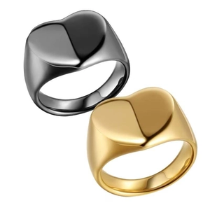 Detailed macro view of heart signet rings in gold and black stainless steel finishes.