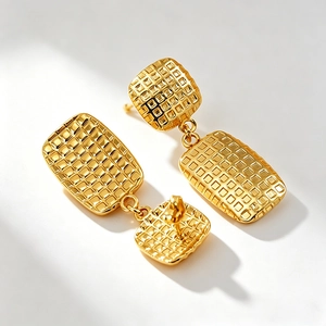 Modern geometric square gold earrings with checkered texture on a white background