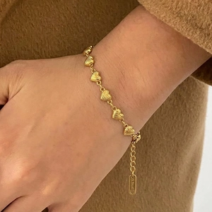 Detail of a gold heart chain bracelet with S.Steel hallmark on the adjustable link
