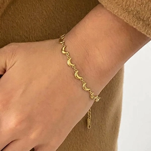Detailed view of moon charms and adjustable clasp on gold stainless steel bracelet