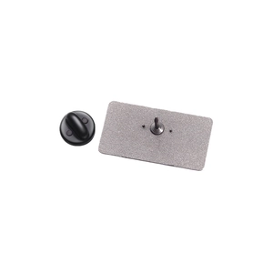 Macro shot of rectangular metal pin back featuring a textured finish and black rubber clutch