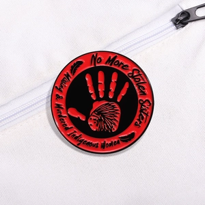 MMIW No More Stolen Sisters red handprint enamel pin on white canvas background