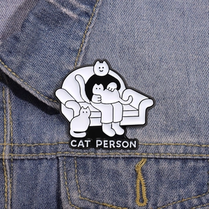 Cartoon enamel cat person badge pin on denim background for bags and clothes accessories