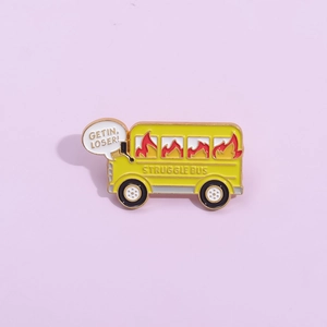 Cartoon yellow school bus enamel pin with Struggle Bus text on light purple background