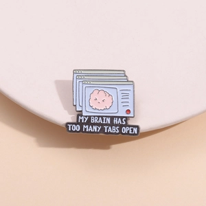 Detail of enamel pin with pink cartoon brain and MY BRAIN HAS TOO MANY TABS OPEN text