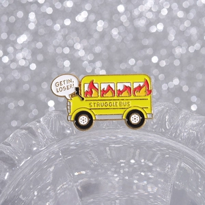 Cartoon enamel struggle bus pin with Get In Loser bubble on a shiny bokeh background