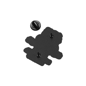 Detail view of the black enamel brooch back with double pins and rubber clutches