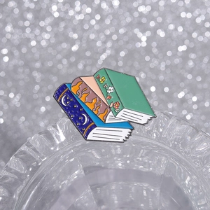Cute stacked books enamel brooch pin with celestial and floral patterns for backpacks