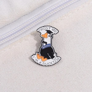 Funny enamel duck pin wearing graduation cap and gown with Trust Me I am a Ducktor text