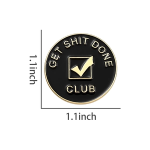Detail view of 1.1 inch circular enamel pin with gold lettering on black metal background