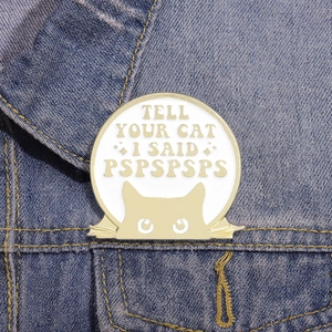 Cartoon cat badge Tell Your Cat I Said Pspspsps on blue denim fabric background