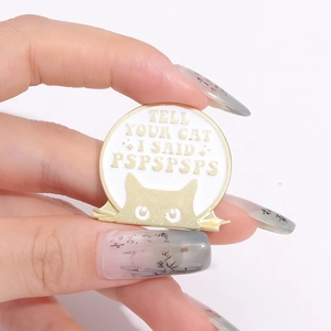 Funny enamel cat badge with Tell Your Cat I Said Pspspsps quote on gold metal base