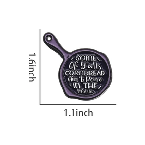Detailed size specifications of creative frying pan enamel pin in 1.6 by 1.1 inches