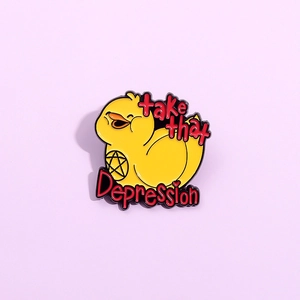 Macro shot of yellow duck enamel pin with Take That Depression text on purple background