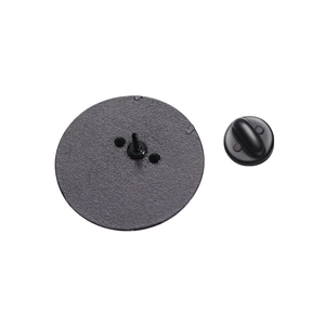 Close-up of black matte metal pin base and secure rubber butterfly clasp backings