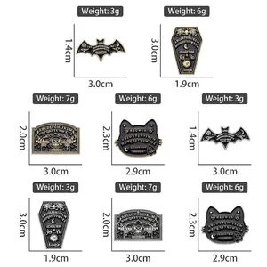 Gothic Ouija board enamel pins featuring bat, coffin, and cat motifs in black and gold