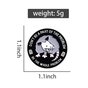 Detail view of round enamel opossum pin showing size 1.1x1.1 inch and 5g weight