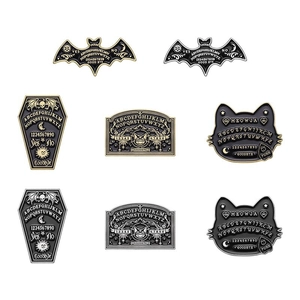 Detailed view of Gothic Ouija board enamel pins featuring bat and coffin designs