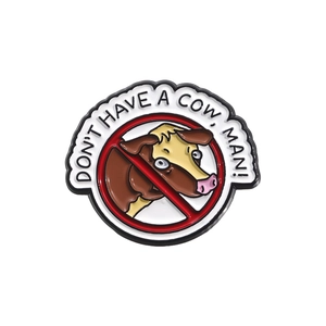 Detailed macro view of an enamel bull badge with Don't Have A Cow Man slogan