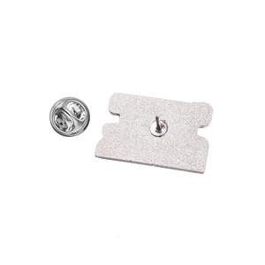 Detailed view of the metal brooch back with butterfly clasp and silver pin backing