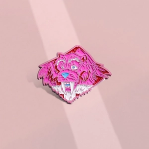 Artistic pink beast-shaped enamel pin badge featuring colorful details on a metal surface
