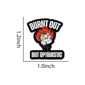 Macro detail of burnt out but optimistic enamel pin showing 1.2 x 1.0 inch dimensions
