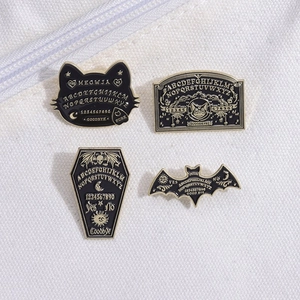 Set of 4 black enamel bat and coffin pins with vintage occult ouija board designs