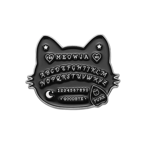 Detailed view of meowja enamel pin with ouija board design and silver cat lettering