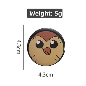 Detail of round tinplate badge featuring a bird character, 4.3cm diameter and 5g weight
