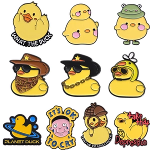 Set of 9 cute cartoon yellow duck enamel pins with creative slogans on white background
