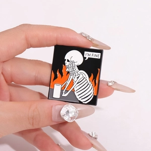 Ghost skull enamel pin with I'M FINE text bubble and orange fire on black background