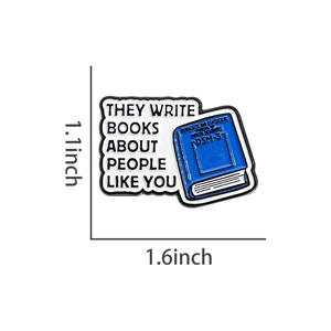 Detail view of the enamel book badge with dimensions 1.1x1.6 inches and text details
