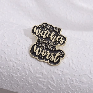 Black enamel brooch with gold stars and Of All The Witches Working I'm The Worst slogan