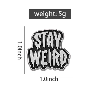 Macro shot of 1-inch Stay Weird enamel pin badge with black lacquer finish and 5g weight