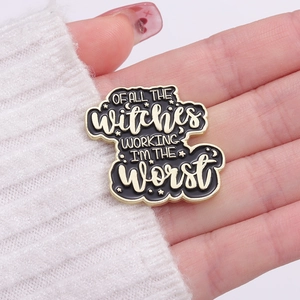 Macro detail of enamel witch badge showing text of all the witches working I am the worst
