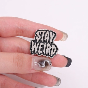 Punk style 'STAY WEIRD' black and white enamel pin made of alloy for bags and jackets