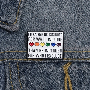 Rectangular enamel rainbow hearts brooch pinned on denim jacket for casual style