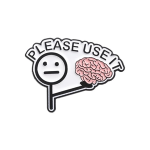 Detail of metal enamel brooch featuring a stickman holding a pink brain with Please Use It text