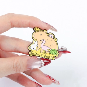Detail of Capybara enamel pin with animals and friend to all text engraving
