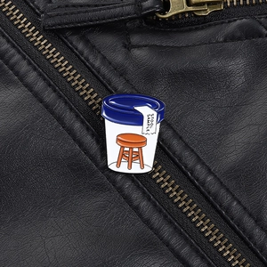 Detail of creative enamel stool sample pin on black leather jacket with clear engraving