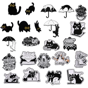 Set of 24 cute cartoon black cat enamel pins featuring various creative feline designs