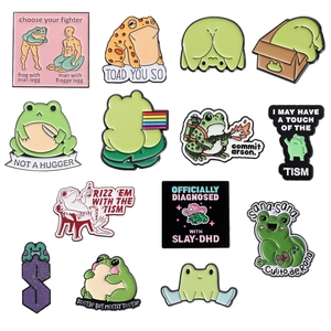 Set of 13 creative cartoon frog enamel pins with funny internet meme designs on white background