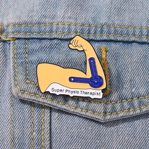 Creative Super Physio Therapist enamel pin on blue denim jacket, fitness arm design