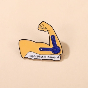 Macro shot of Super Physio Therapist enamel pin featuring a strong arm and protractor